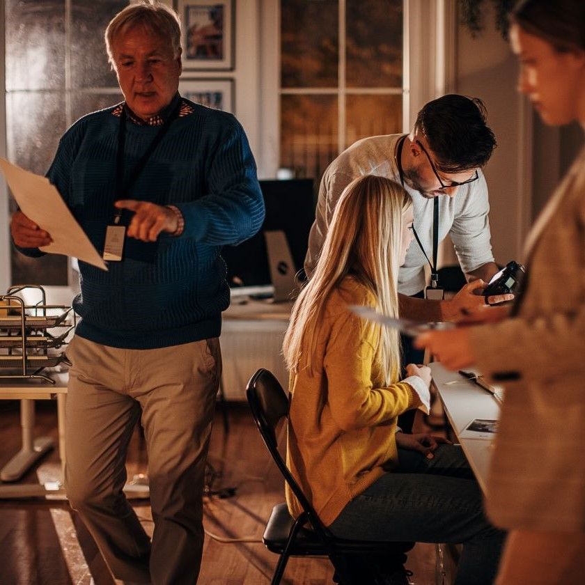 Group works late in a creative office setting, suggesting the high-pressure moments where miscommunication can be costly.